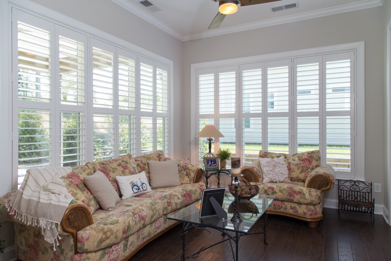 Airy sunroom with faux wood shutters in New Brunswick.